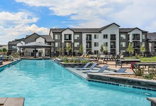 A high-resolution photograph of the Outlook Table Mesa apartments sitting near a swimming pool.