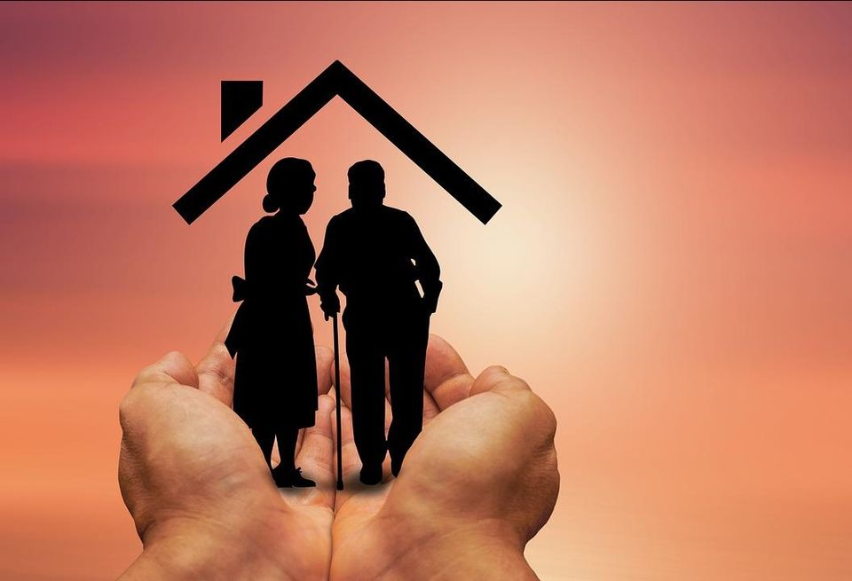Hands holding senior housing logo