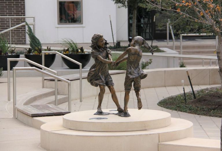 Angela Mia De La Vega’s bronze and clay Whirlwind by Lot A Apartments depicts two young girls dancing. CityLine in Richardson
