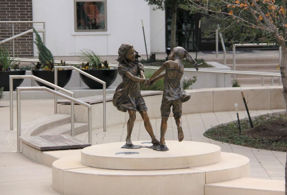 Angela Mia De La Vega’s bronze and clay Whirlwind by Lot A Apartments depicts two young girls dancing. CityLine in Richardson
