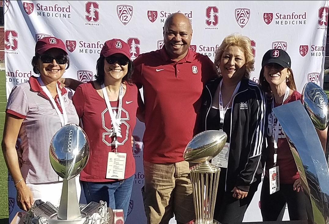 PGIM Real Estate Finance's Marcia Diaz (second from left) with her sisters and Stanford Football Head Coach David Shaw at a Stanford Women’s Football Clinic.