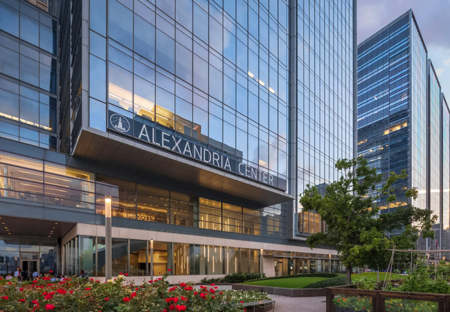 Glass building labeled "Alexandria Center" with reflective windows