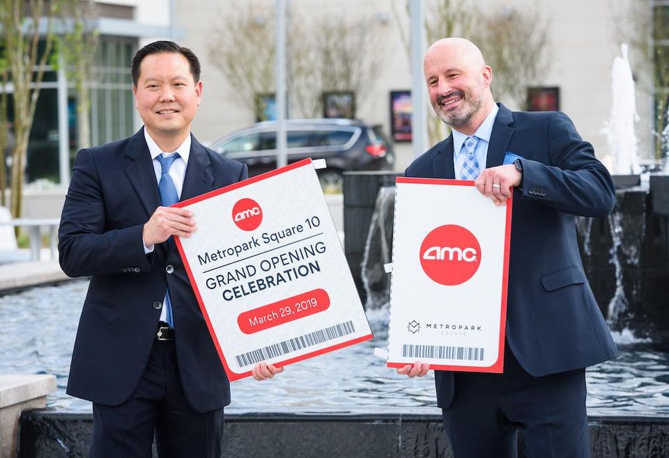 Sam Moon Group Vice President and general counsel Daniel Moon and Vice President of Construction ShaneWilliams celebrate the grand opening of theAMC Metropark Square 10.