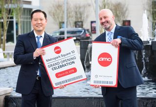 Sam Moon Group Vice President and general counsel Daniel Moon and Vice President of Construction Shane
Williams celebrate the grand opening of the
AMC Metropark Square 10. 
