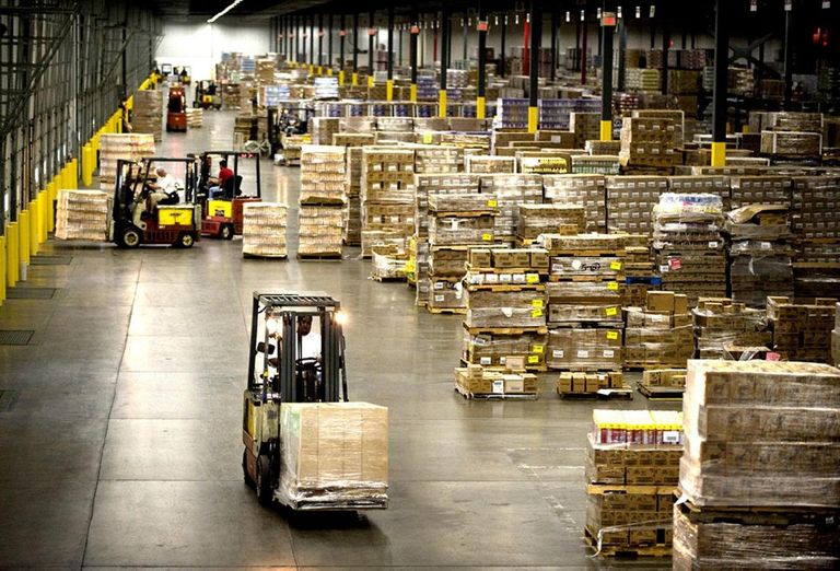 A warehouse with forklifts in use