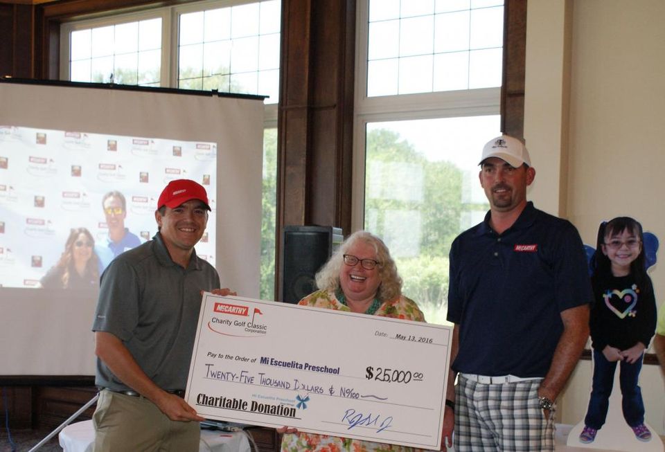 McCarthy’s controller, Michael Schulte (left) and McCarthy’s Texas regional president, Ray Sedey (right) present Mi Escuelita’s president and CEO, Gayle Nave with the check at The Tribute at The Colony.