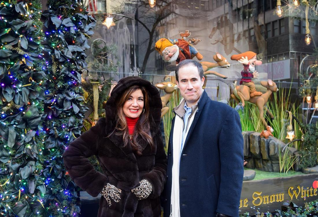 Eastern Consolidated's Adelaide Polsinelli and New York Historical Tours' Kevin Draper in front of the Saks Fifth Avenue window display