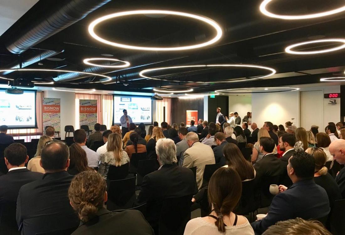 Attendees listen to Downtown Center Business Improvement District’s Elan Shore give opening remarks at Bisnow's Los Angeles Office: Workplace of the Future event at Convene in Los Angeles. Downtown Center Business Improvement District’s Elan Shore gave opening remarks at Bisnow's Los Angeles Office: Workplace Of The Future Event Aug. 29, 2018 in the Convene space at the Wells Fargo Center in downtown Los Angeles.