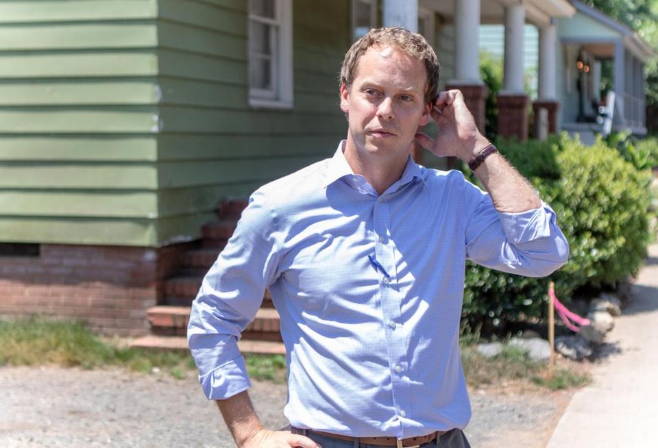 A.J. Klenk in front of an old mill house in Charlotte that will be transformed into a farm-to-table restaurant. The office for Air Hospitality, another of Klenk's businesses, is shown in the background.