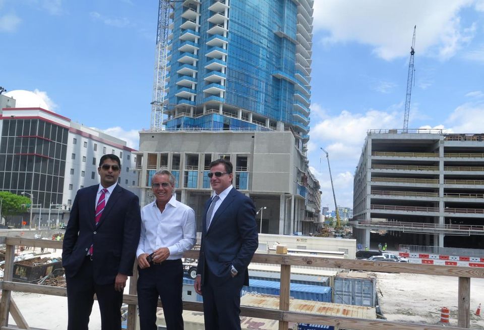 Miami Worldcenter Associates Managing Partner Nitin Motwani, Forbes Co. President Nate Forbes and Royal Palm Cos. founder Dan Kodsi are all partners in Miami Worldcenter. A condo tower, Paramount, is under construction behind them.