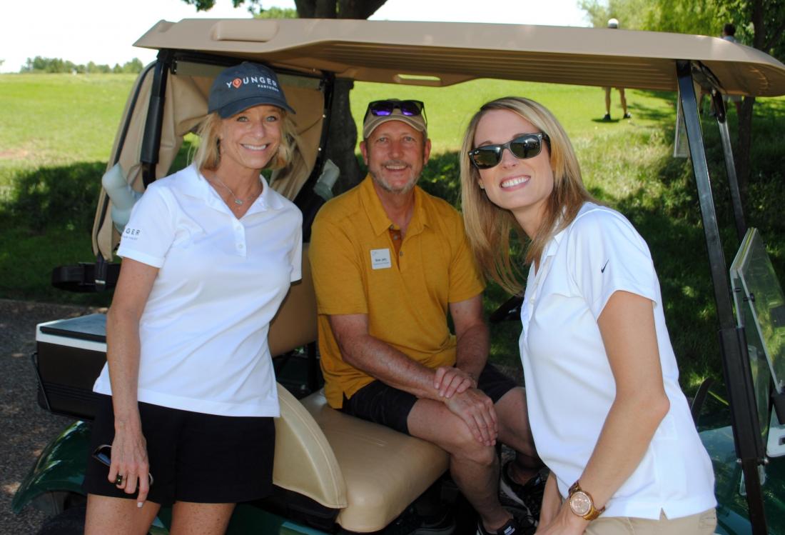 Younger Partners’ Kathy Permenter with NTCAR’s Brian Jetty and Younger Partners’ Lacey Queen at the NTCAR annual golf tournament in June.