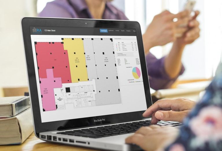 Floor plan on laptop with people