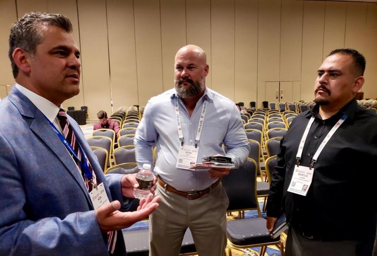 Kosmont Executive Vice President Ken K. Hira speaks to city officials from the city of Rancho Mirage after a panel at the ICSC RECon convention in Las Vegas.