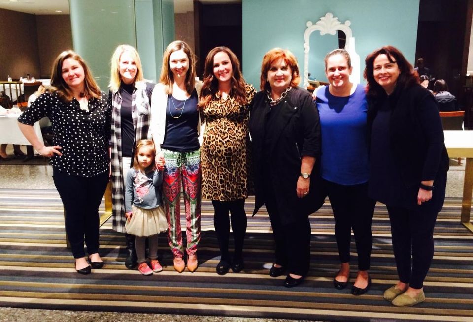 Amy Tharp (center) at her baby shower; COO of Downtown Dallas Inc