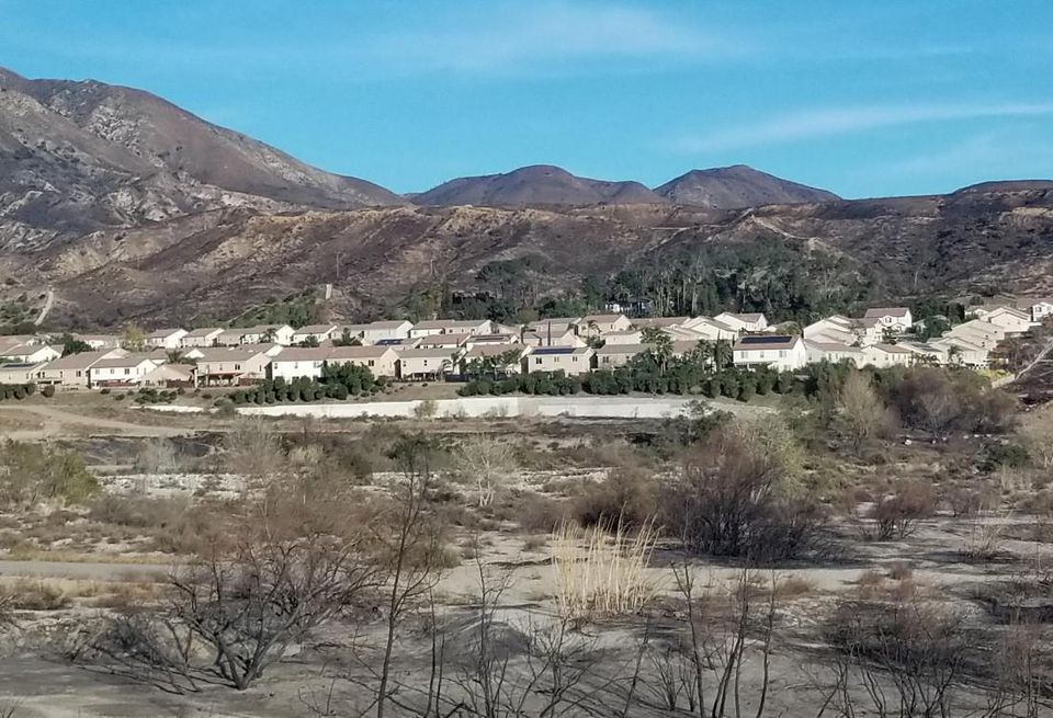 The photo shows how close the Creek Fire was to some neighborhoods in Sylmar. The Creek Fire has charred more than 15,000 acres and is 95% contained as of Monday. The wildfire has burned down 123 structures, nearly half were houses.