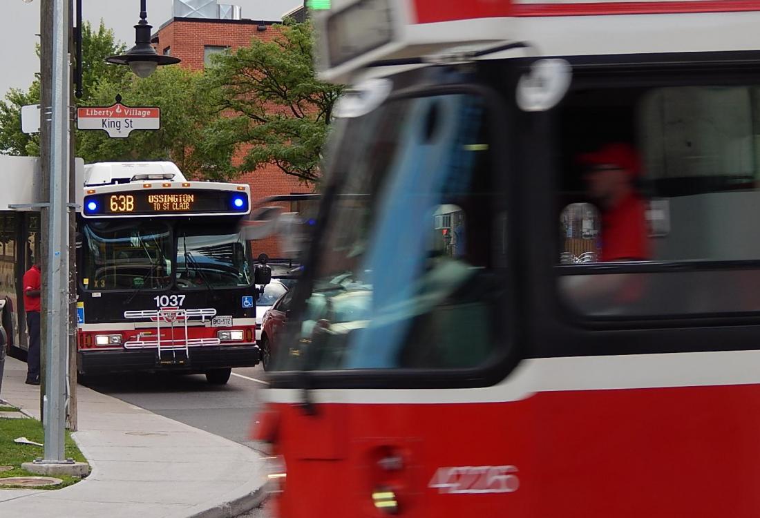 A street car passes a bus in Toronto