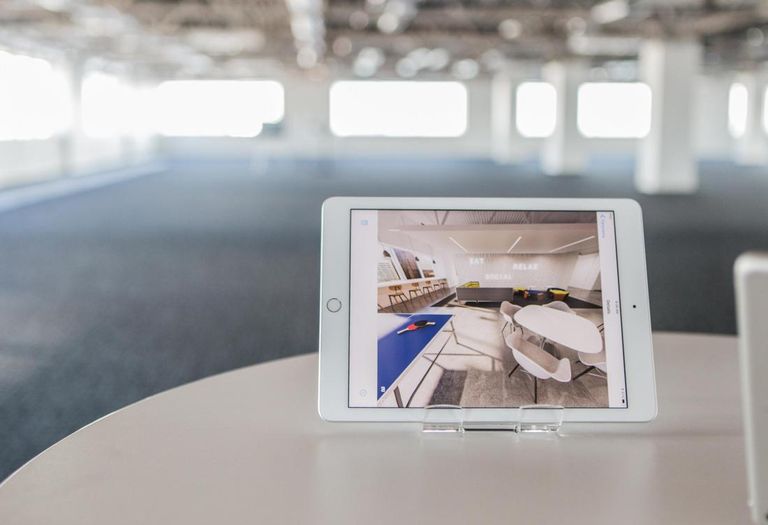 Redline Design Group created a 3D floor plan for 300 South Brevard. An iPad shows what the space will look like with an open office concept. 
