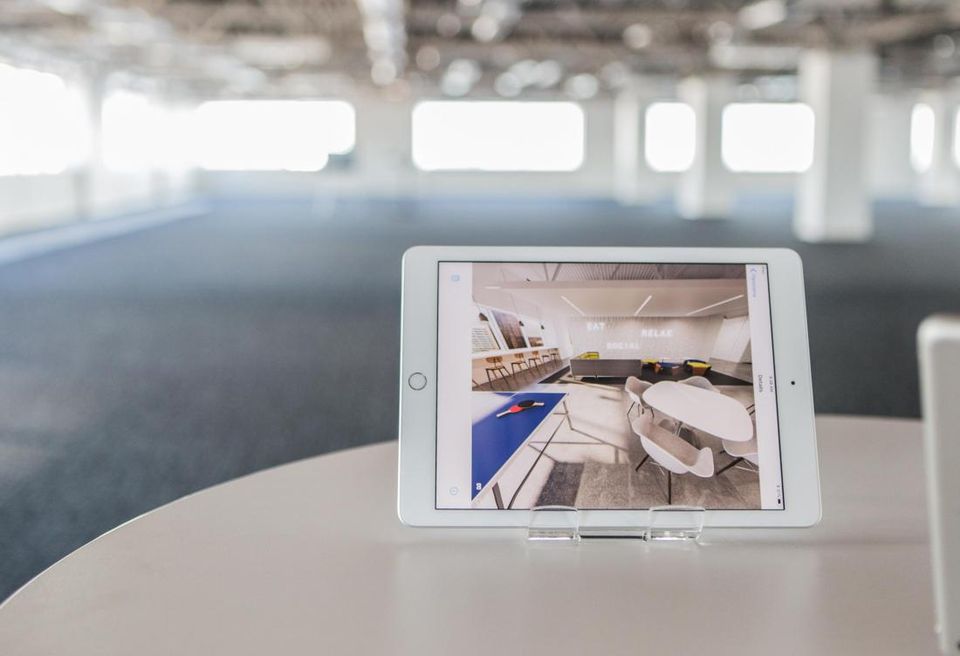 Redline Design Group created a 3D floor plan for 300 South Brevard. An iPad shows what the space will look like with an open office concept.