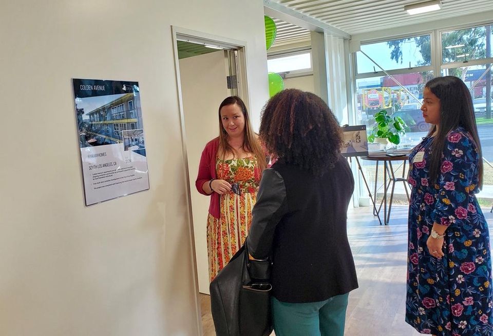 Crate Modular's Amanda Gattenby talks to a person about the company's ADU offerings at the Create Modular headquarters in Carson.