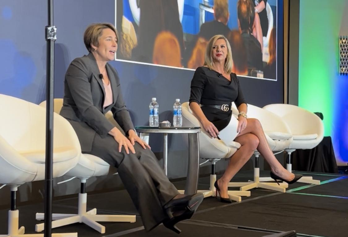 Gov. Maura Healey and MassBio CEO Kendalle Burlin O'Connell speaking at the MassBio State of Possible conference on Tuesday.