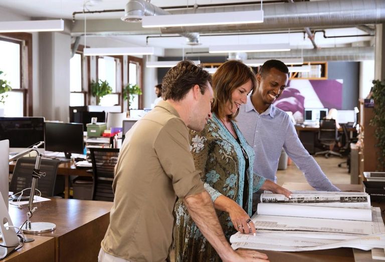 Omgivning Founder and Principal Karin Liljegren looks over design schematics with her team