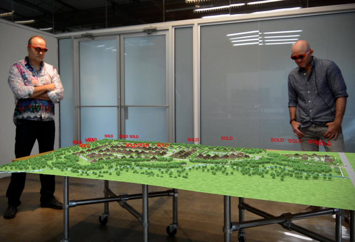 M2 Studio employees watch a visualization of a new housing development.