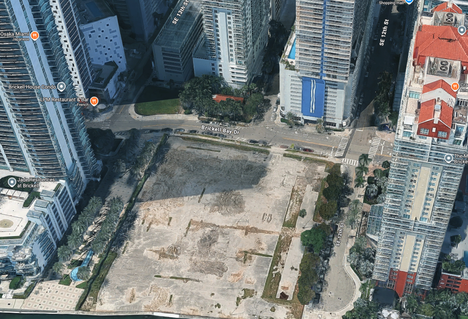 Ken Griffin owns the vacant waterfront lot on Brickell Bay Drive, as well as the historic cottage, parking garage and Solaris condo building across the street.