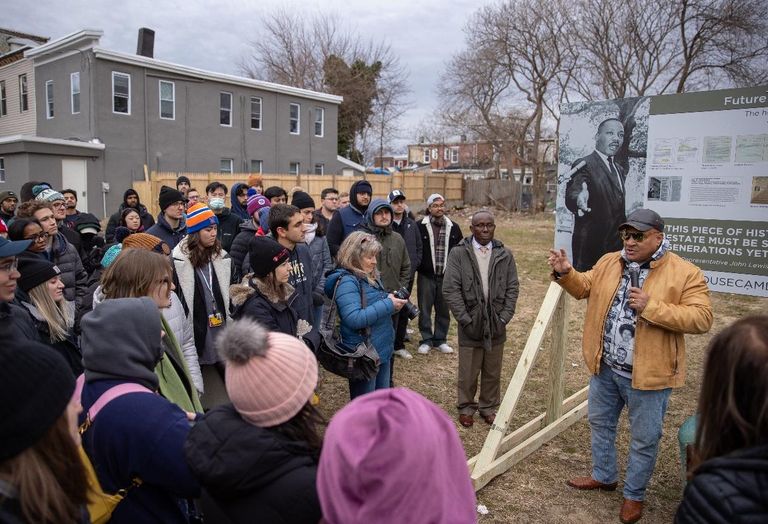 Amir Khan speaking to a crowd in front of the MLK Jr. House in Camden.