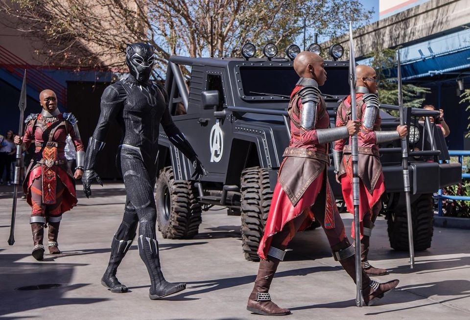The king of Wakanda, Black Panther, and his royal guards walk to a meet-and-greet area at the Hollywood Backlot area of Disney California Adventure park in Anaheim.