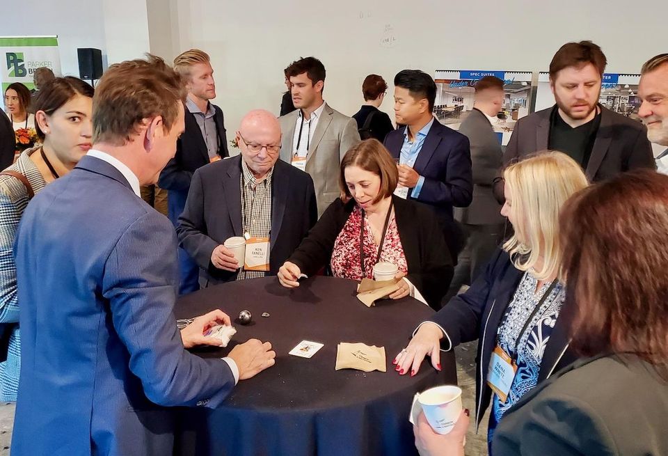 A magician entertains attendees at Bisnow's State of the Valley and Tri-Cities event at New York Life's 2300 West Empire Avenue building in Burbank