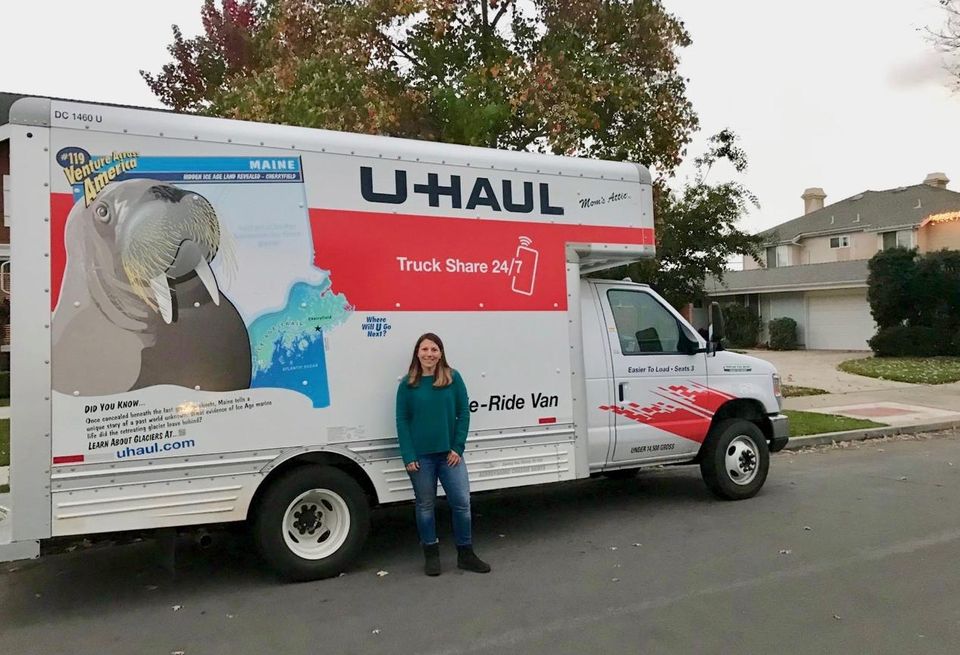 Jenifer Levy, an Orange County resident, poses in front of the U-Haul she filled up with donations to take to Camp Fire victims.