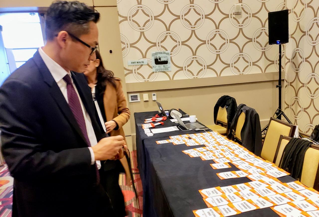 An attendee picks up his badge for BASH Los Angeles. 