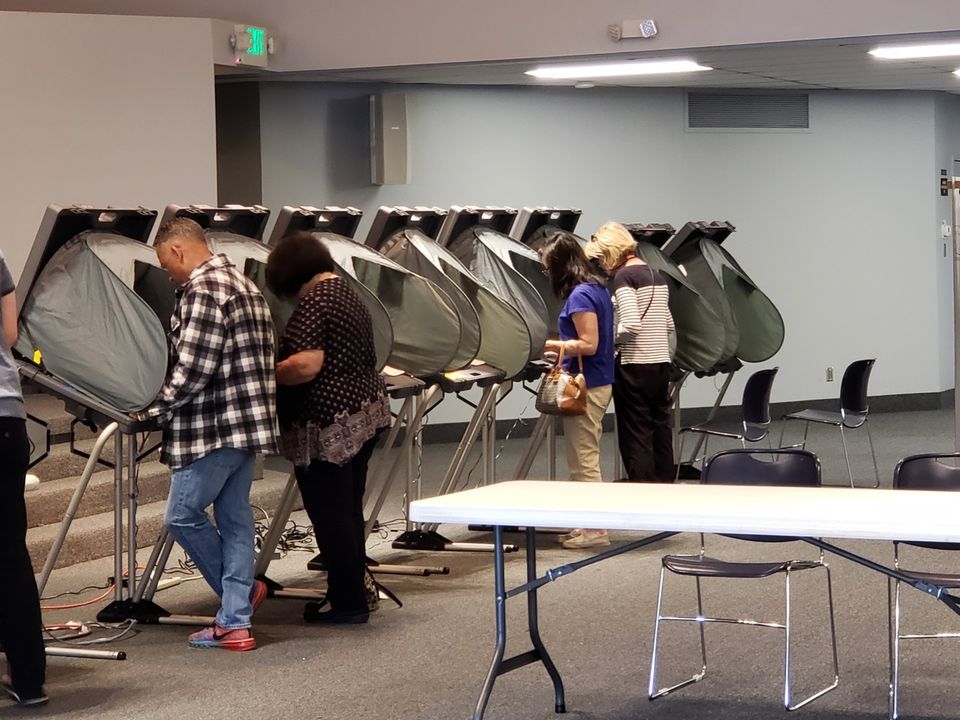 People voting at a voting booth in Orange County, California