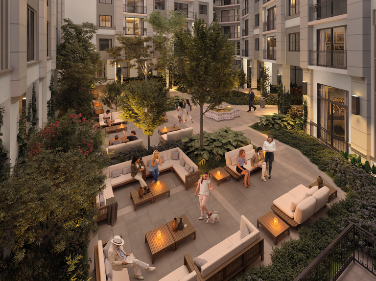 A cozy courtyard with people relaxing on sofas, talking, and walking a dog, surrounded by lush greenery and lit by soft, warm lights.