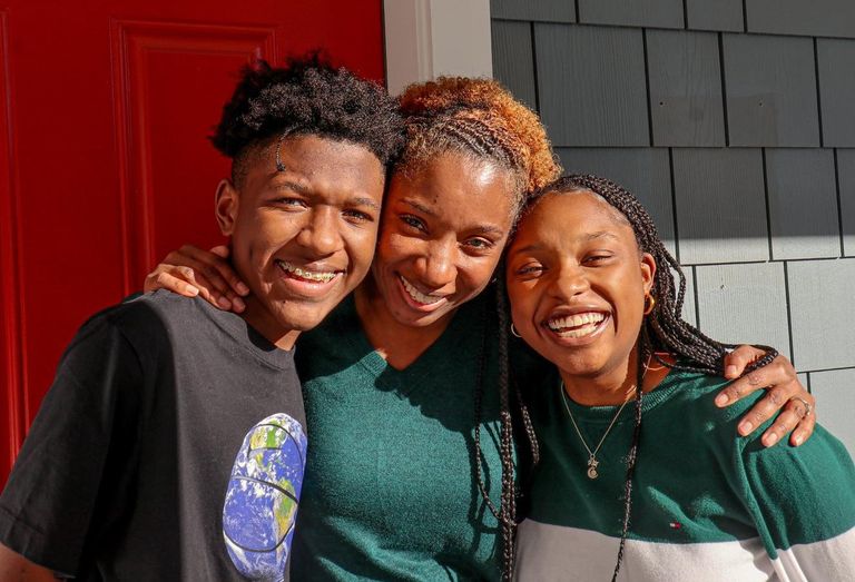 Robin Valentine and two of her children outside of their Dorchester home.