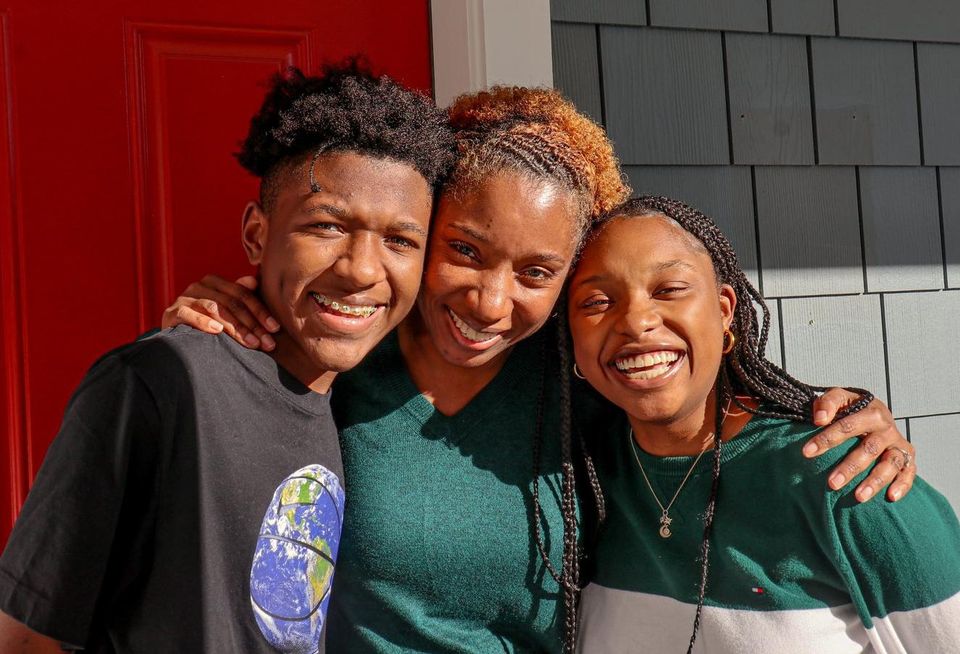 Robin Valentine and two of her children outside of their Dorchester home.