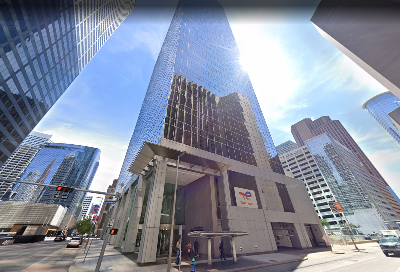 An upward looking angle of a skyscraper from street level in a downtown setting