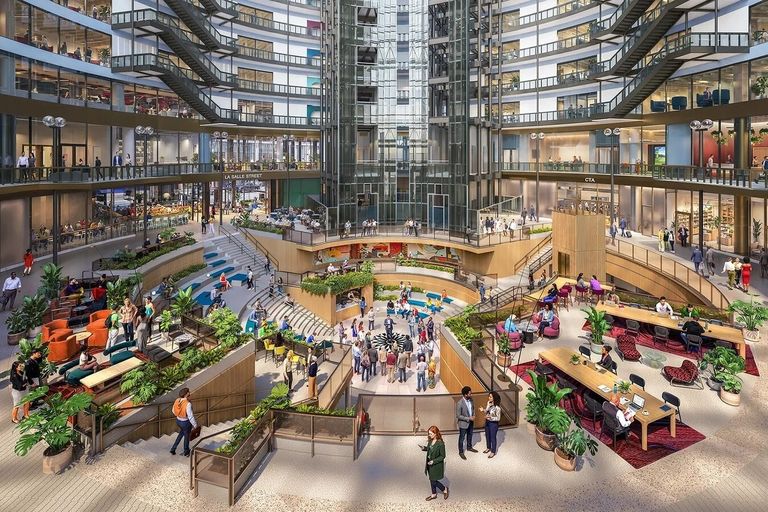 Modern indoor atrium with people working, socializing, and walking on multiple levels. Surrounded by glass walls, plants, and various seating areas.