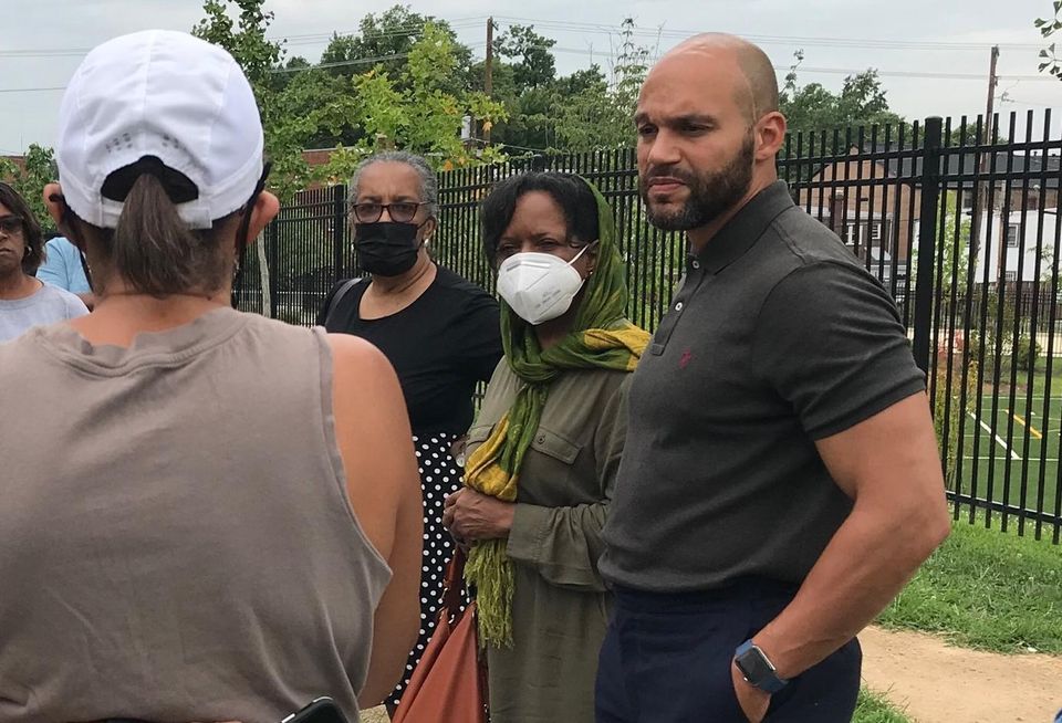Council Member Robert White speaks to residents during a walkthough of ANC 8A