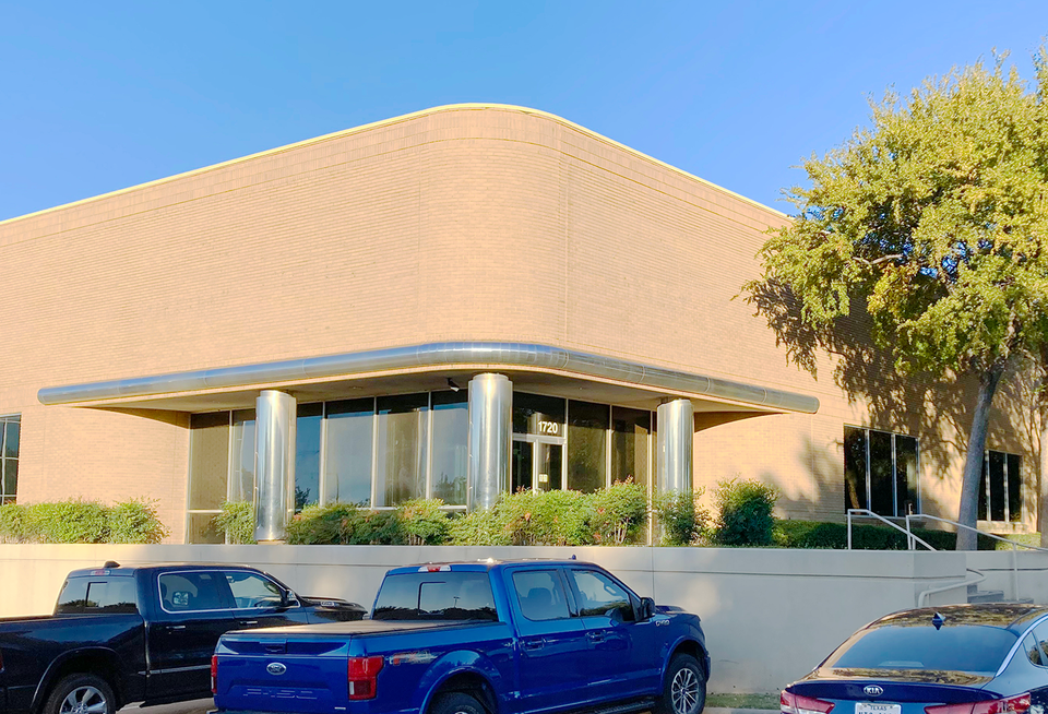 Vehicles packed outside of an office building.