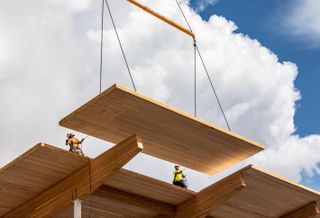 Swinerton Mass Timber crews lower the last Cross-Laminated Timber roof panel into place at the new 83K SF Wingspan Conference and Event Center in Hillsboro, Oregon.