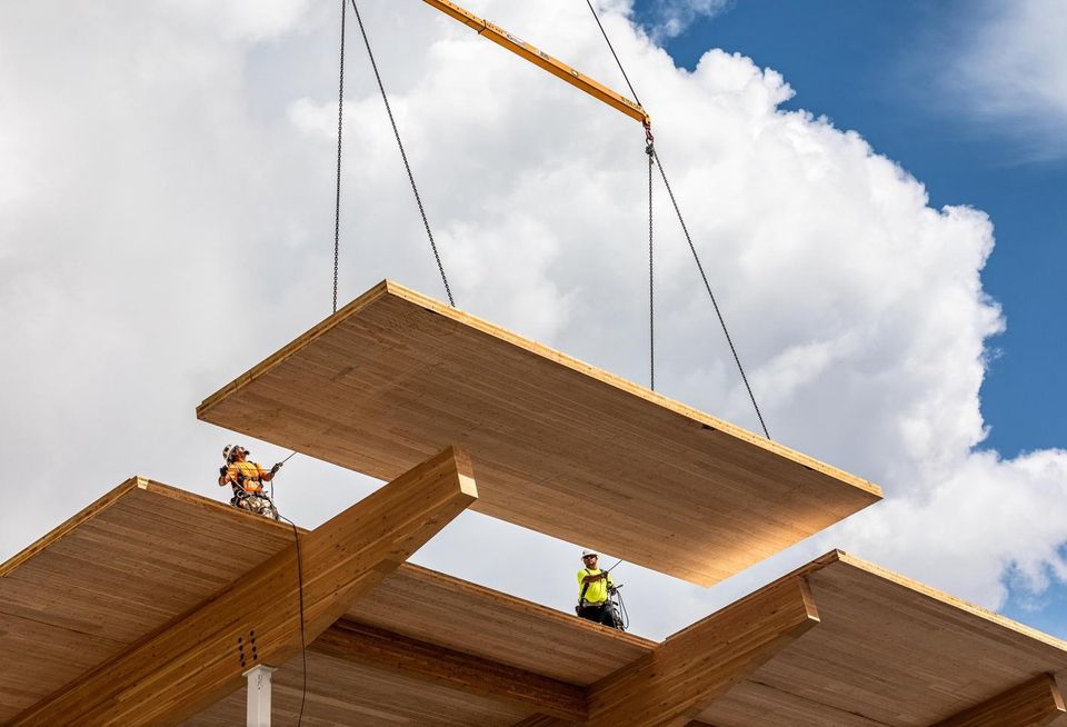 Swinerton Mass Timber crews lower the last Cross-Laminated Timber roof panel into place at the new 83K SF Wingspan Conference and Event Center in Hillsboro, Oregon.