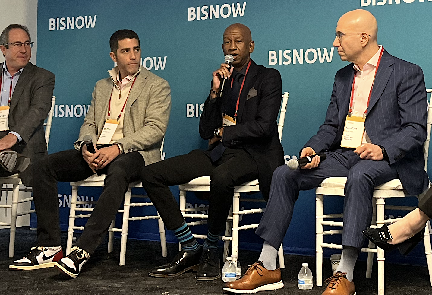 Asland Capital Partners CEO James Simmons, center, speaks at Bisnow's New York City State of the Market event Nov. 16, 2023, flanked by Slate Property Group's Martin Nussbaum and Ariel Property Advisors' Shimon Shkury.