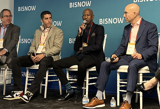 Asland Capital Partners CEO James Simmons, center, speaks at Bisnow's New York City State of the Market event Nov. 16, 2023, flanked by Slate Property Group's Martin Nussbaum and Ariel Property Advisors' Shimon Shkury.