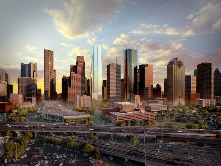 A city skyline at sunset featuring tall skyscrapers, highways with traffic, and scattered clouds in the sky.