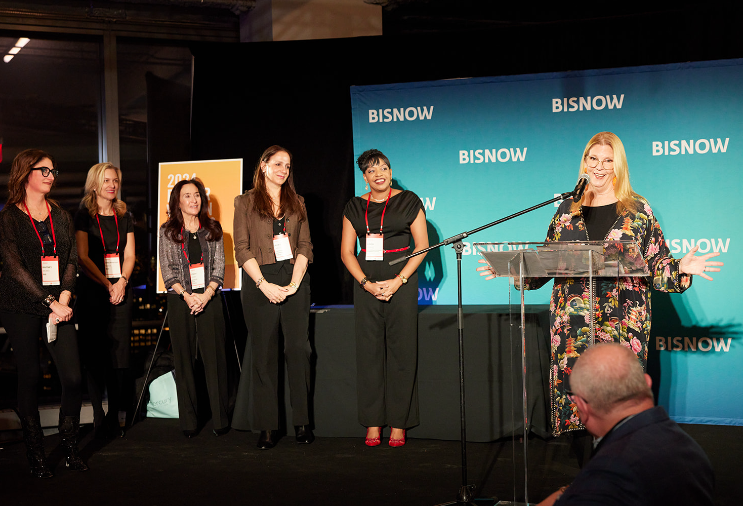 Stacom CRE's Darcy Stacom speaking onstage.