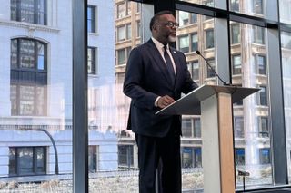 Chicago Mayor Brandon Johnson stands at a lectern.
