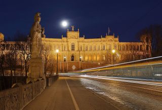 The Maximilianeum, seat of the Bavarian State Legislature, at night with light trails created by a passing streetcar