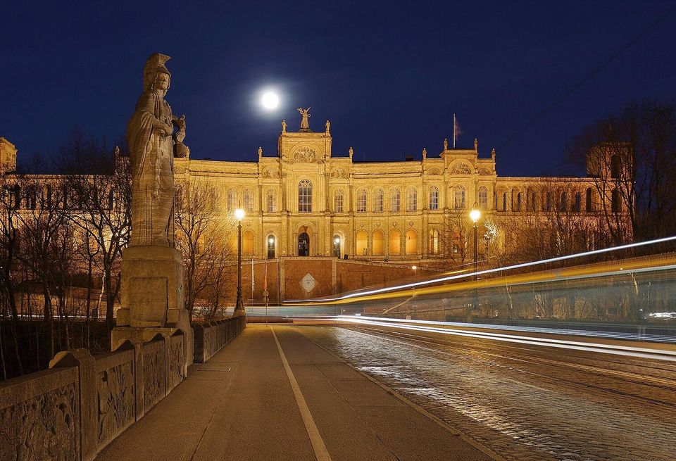 The Maximilianeum, seat of the Bavarian State Legislature, at night with light trails created by a passing streetcar