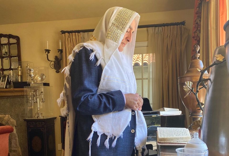Universe Holdings Chairman and CEO Henry Manoucheri praying